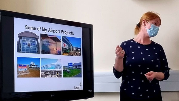 Brandi from Lagan Aviation speaking to the class with a monitor displaying some of their airport projects