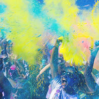 people throwing coloured powder in the air