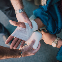 Someone bandaging a hand