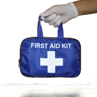 A hand holding a first aid bag