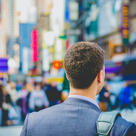 A man looking out onto a bustling city scene A man looking out onto a bustling city scene