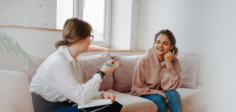Social worker having a friendly conversation with a client Social worker having a friendly conversation with a client