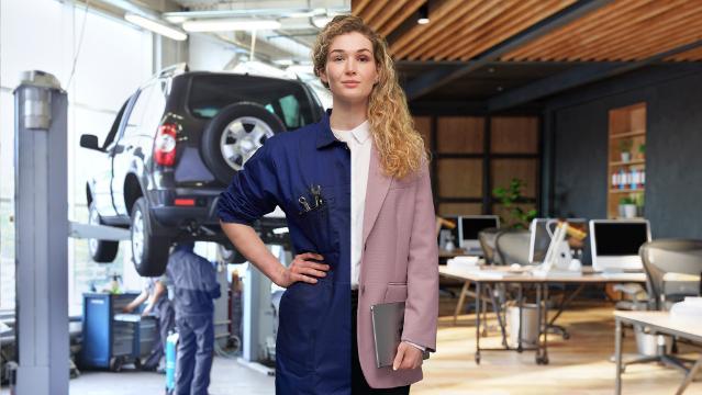 A young female split down the centre shown half dressed as a mechanic and half dressed as an office worker