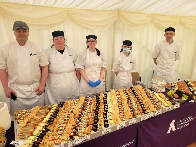 NC Professional Cookery students standing at the buffet they have created for SAMS launch events