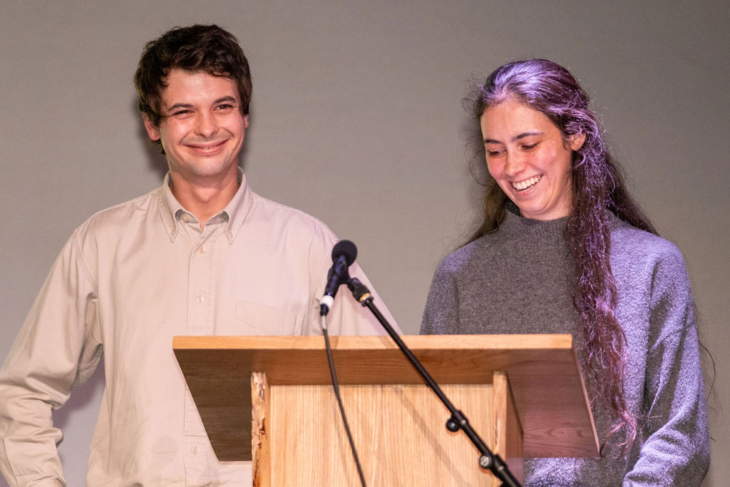 Guest speakers Cal Hunter and Claire Segeren standing at a lectern giving their speech