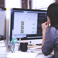 woman looking at desktop screen