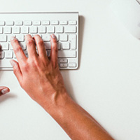 person typing on a keyboard