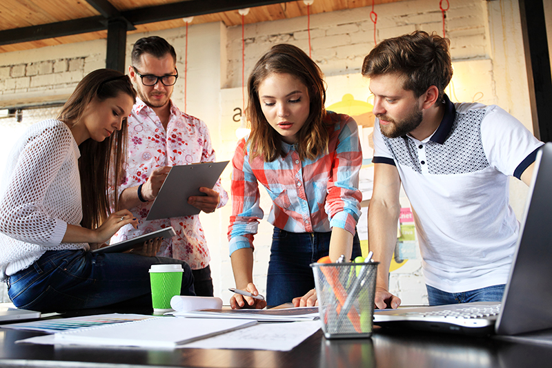 Group of four people having a casual business discussion