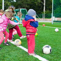 Young children playing football