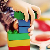 Toddler playing with colourful blocks